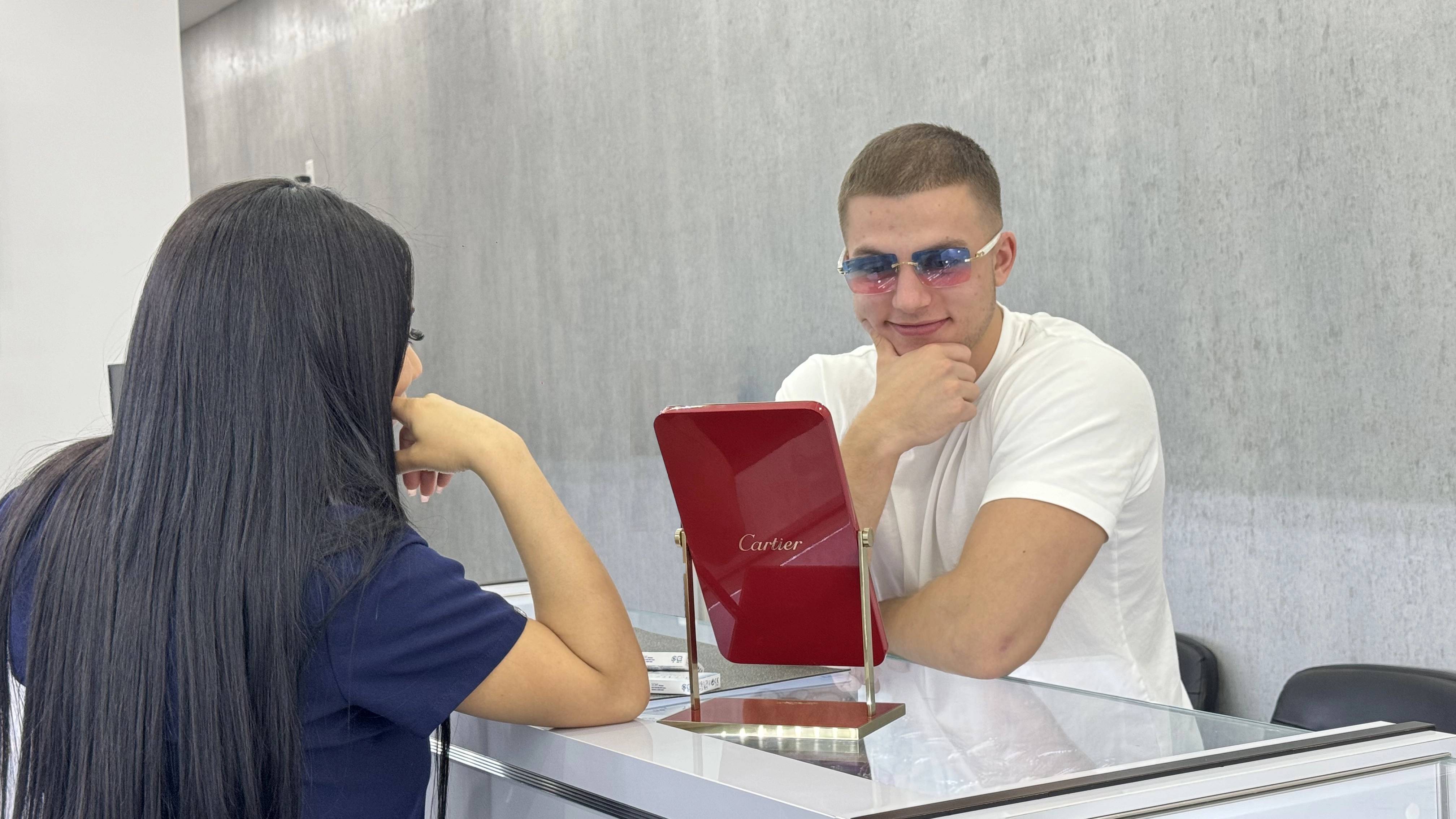 Customer trying on Cartier designer sunglasses at M&N Optical